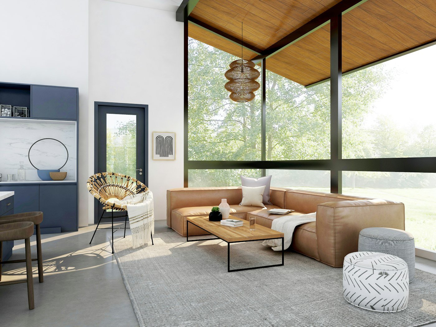 A tan leather sofa, a wicker chair, a wood ceiling, and a wall of glass looking onto trees